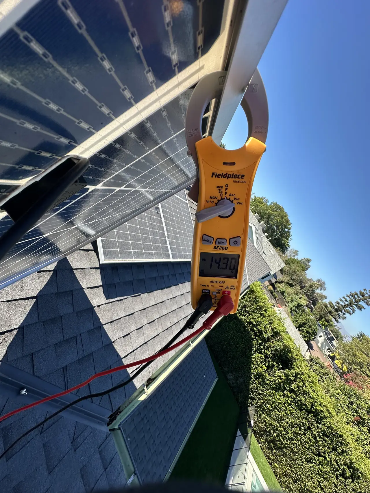 Clamp meter reading current on module leads at the edge of an array, Valley Village