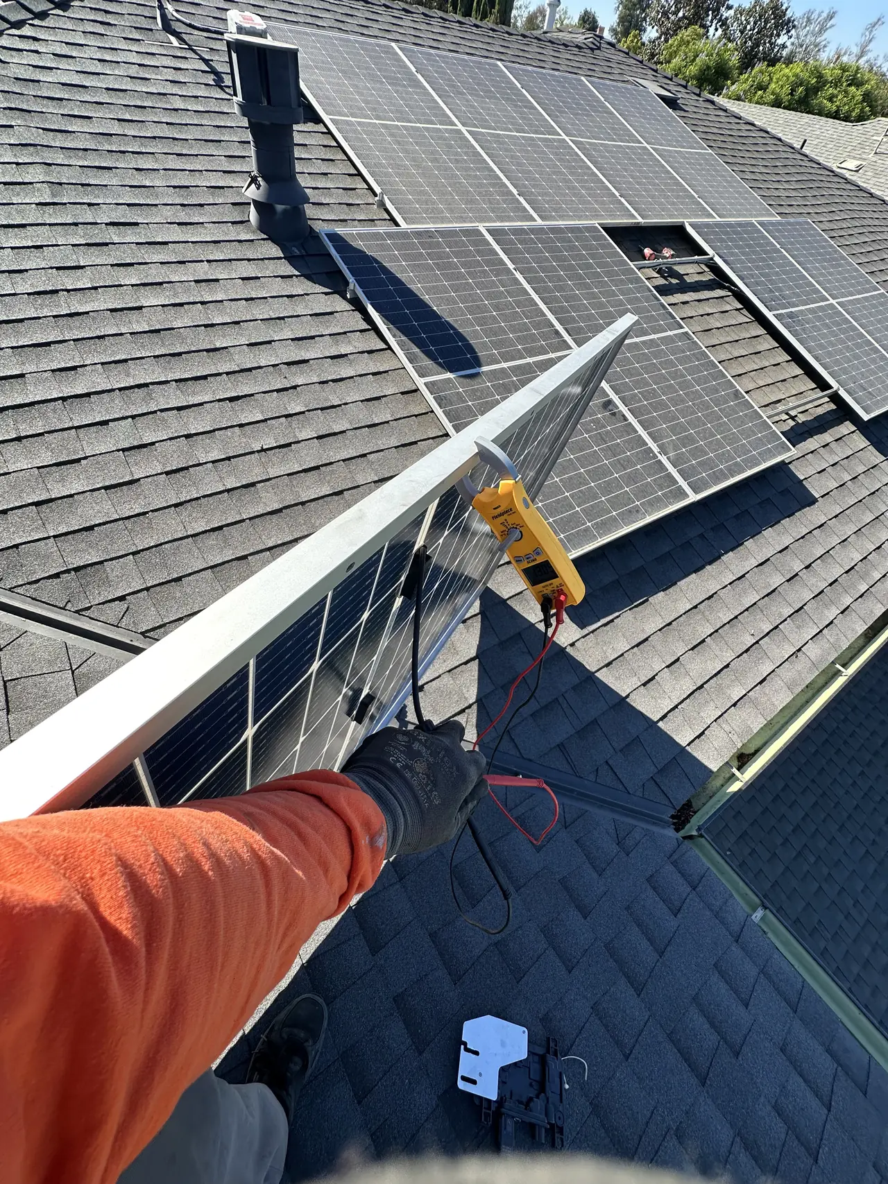 Module lifted from the rail to reach the microinverter mounted beneath it, Valley Village