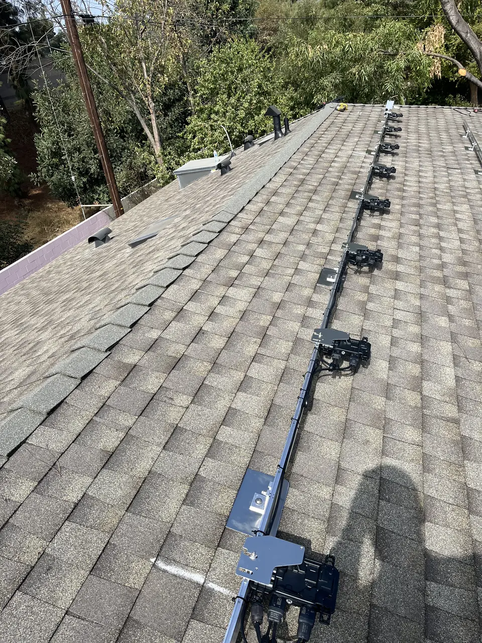 Solar panel mounting detail on a composition shingle roof in Van Nuys, CA