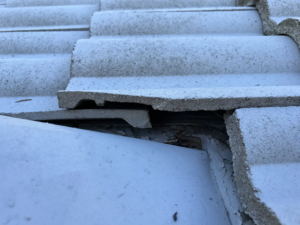 Cracked concrete roof tiles photographed close up before work begins, Van Nuys, Los Angeles
