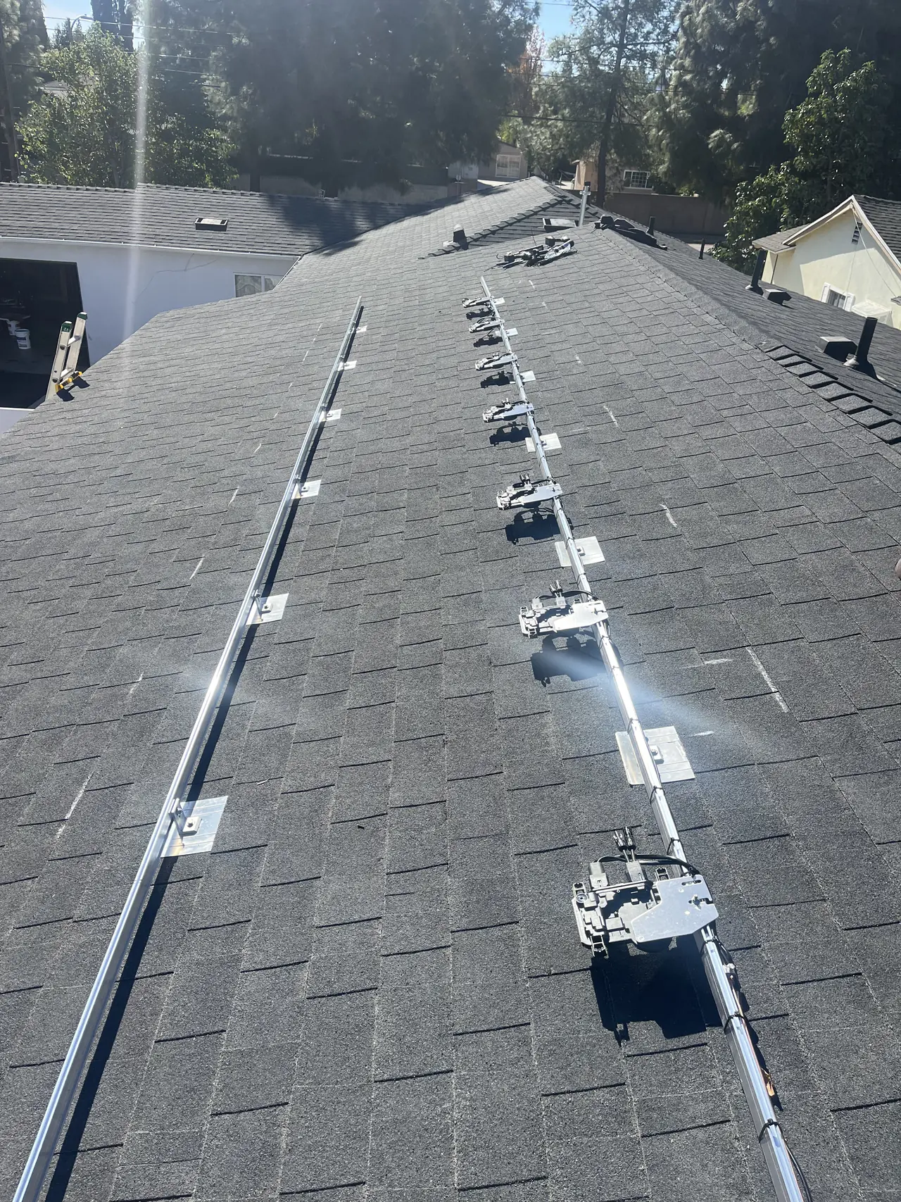 Mounting rails and flashing on a new composition shingle roof, West Hills