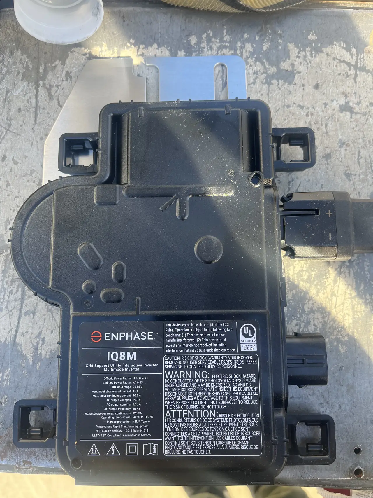 Enphase microinverter mounted under the rail, West Hills