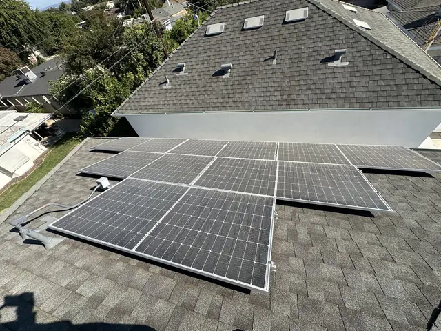 Two solar arrays on a shingle roof seen from above, Winnetka