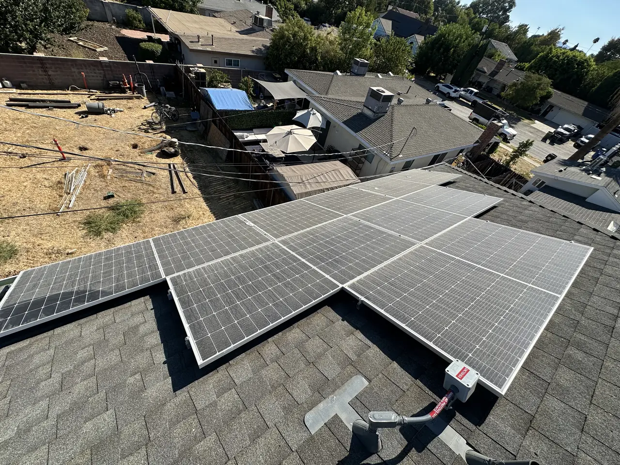 Solar arrays on adjacent roofs with a residential street beyond, Winnetka