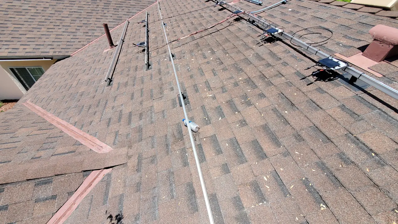 Mounting rails laid across a composition shingle roof, Winnetka