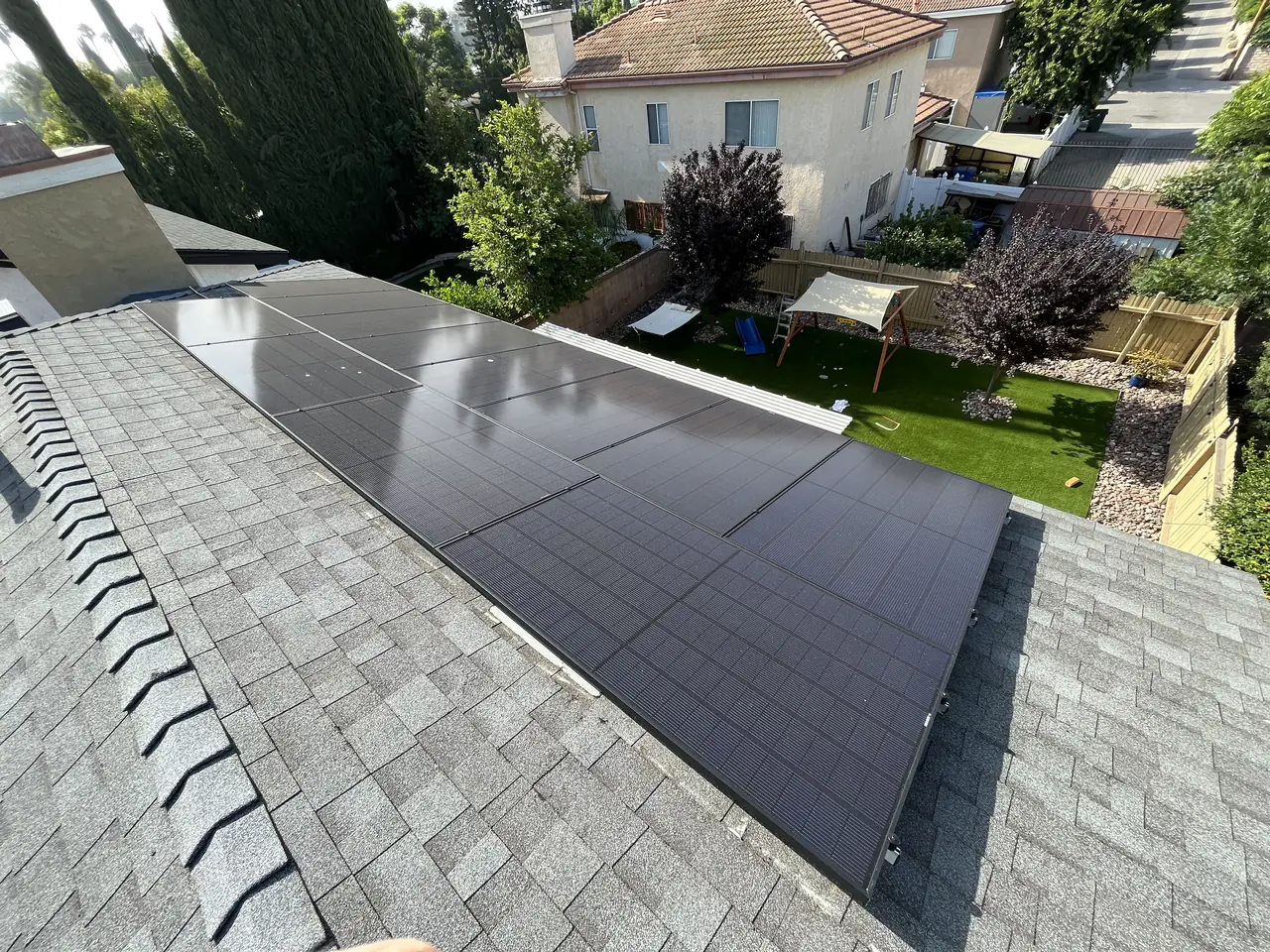 Solar modules across a shingle roof seen from the ridge, Winnetka