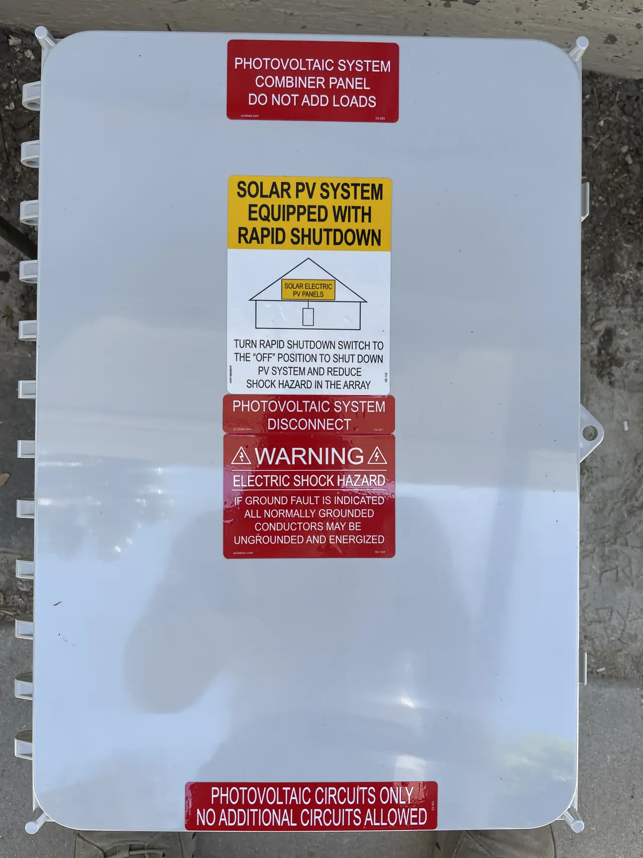 The closed cover of a photovoltaic combiner panel with rapid shutdown and warning labels, Woodland Hills