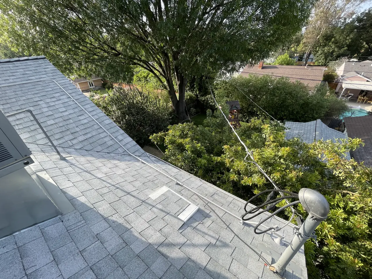 A service weather head and overhead conductors running to the edge of the roof above the garden, Woodland Hills