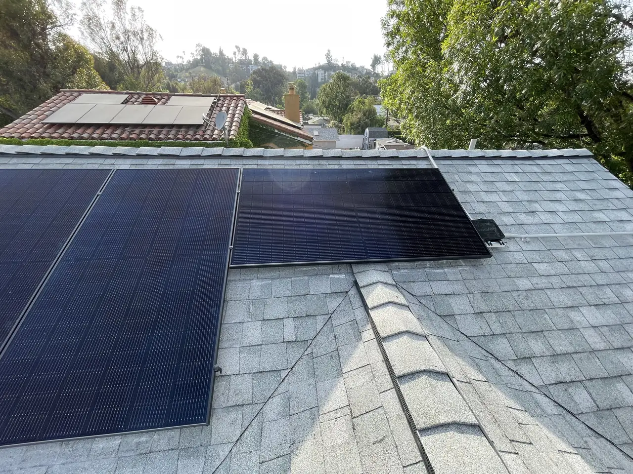 The finished array on the shingle roof with the valley and neighboring rooftops behind, Woodland Hills