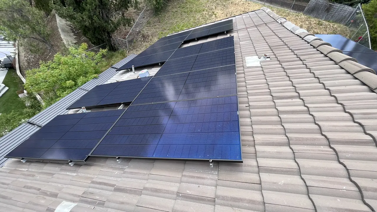 Solar modules meeting the edge of the concrete tile field on a hipped roof, Woodland Hills