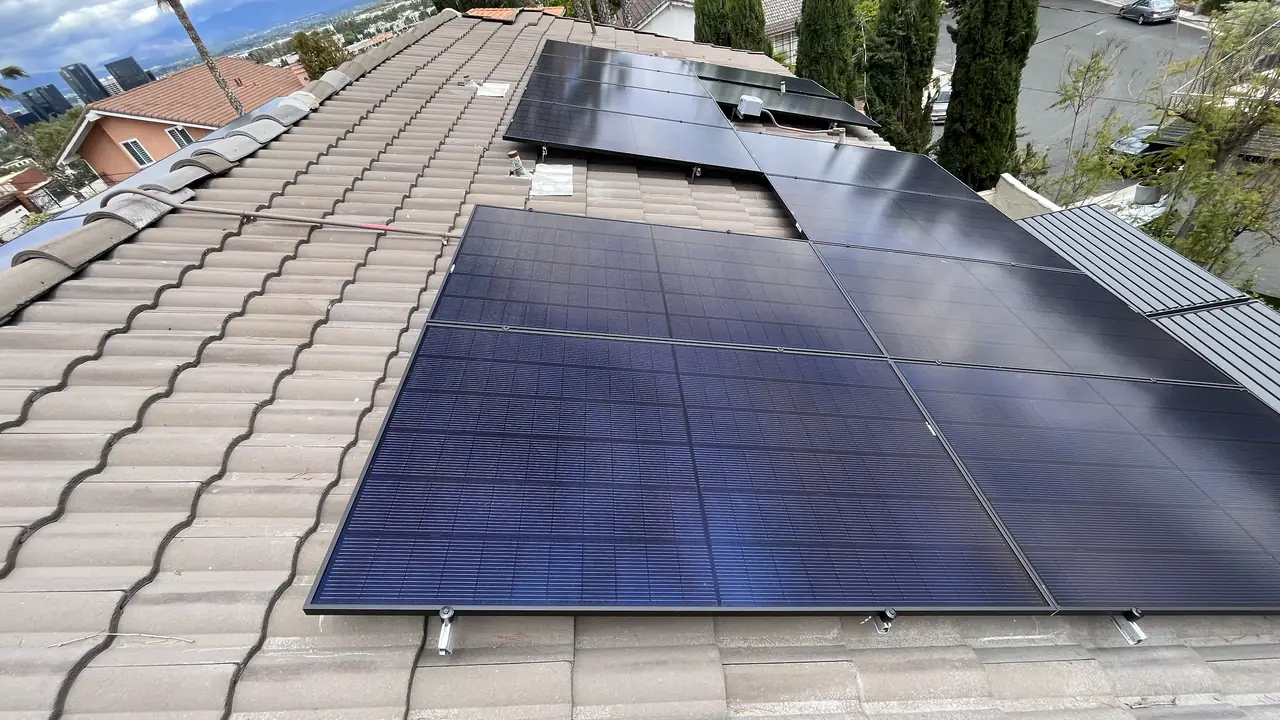 The finished array across the tile roof with trees and rooftops behind, Woodland Hills