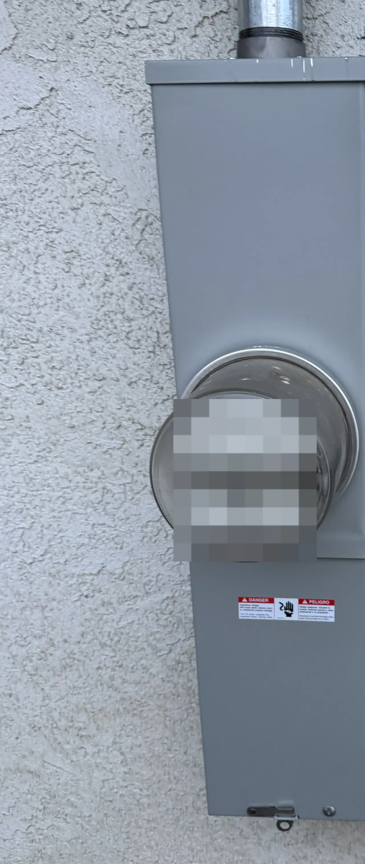 A new meter and main breaker enclosure mounted on a stucco exterior wall, Woodland Hills