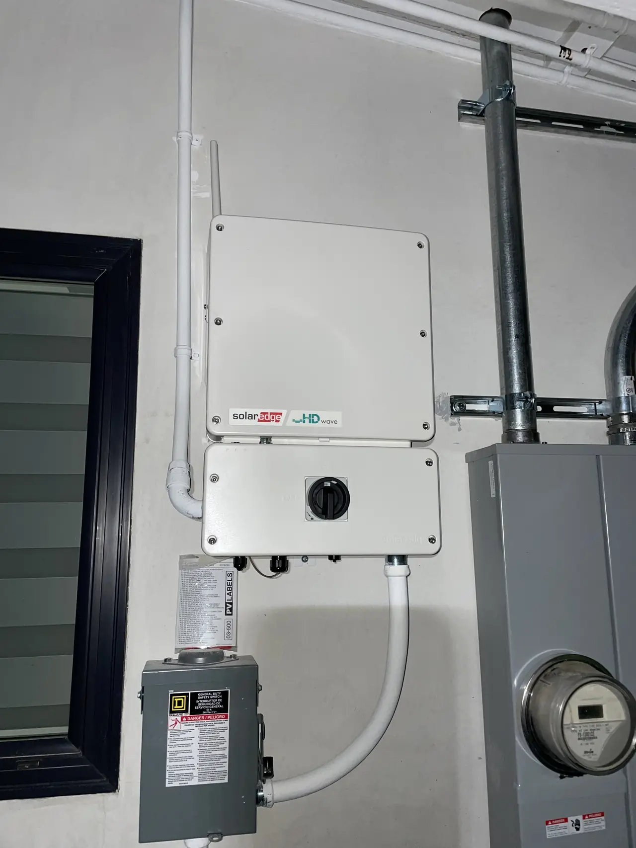 Electrical equipment mounted along the exterior wall of a house with the sky above, Woodland Hills