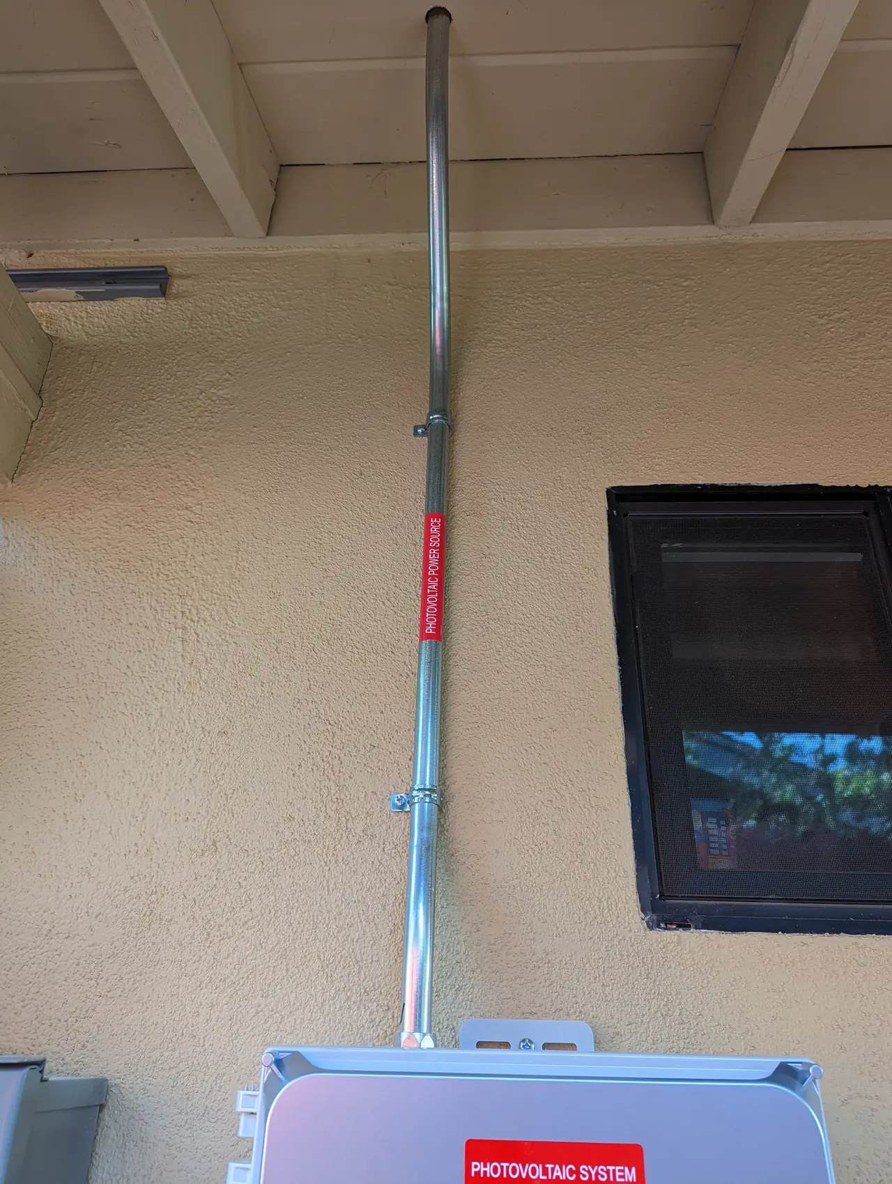 Conduit from the roof brought down along the underside of the eave, Woodland Hills